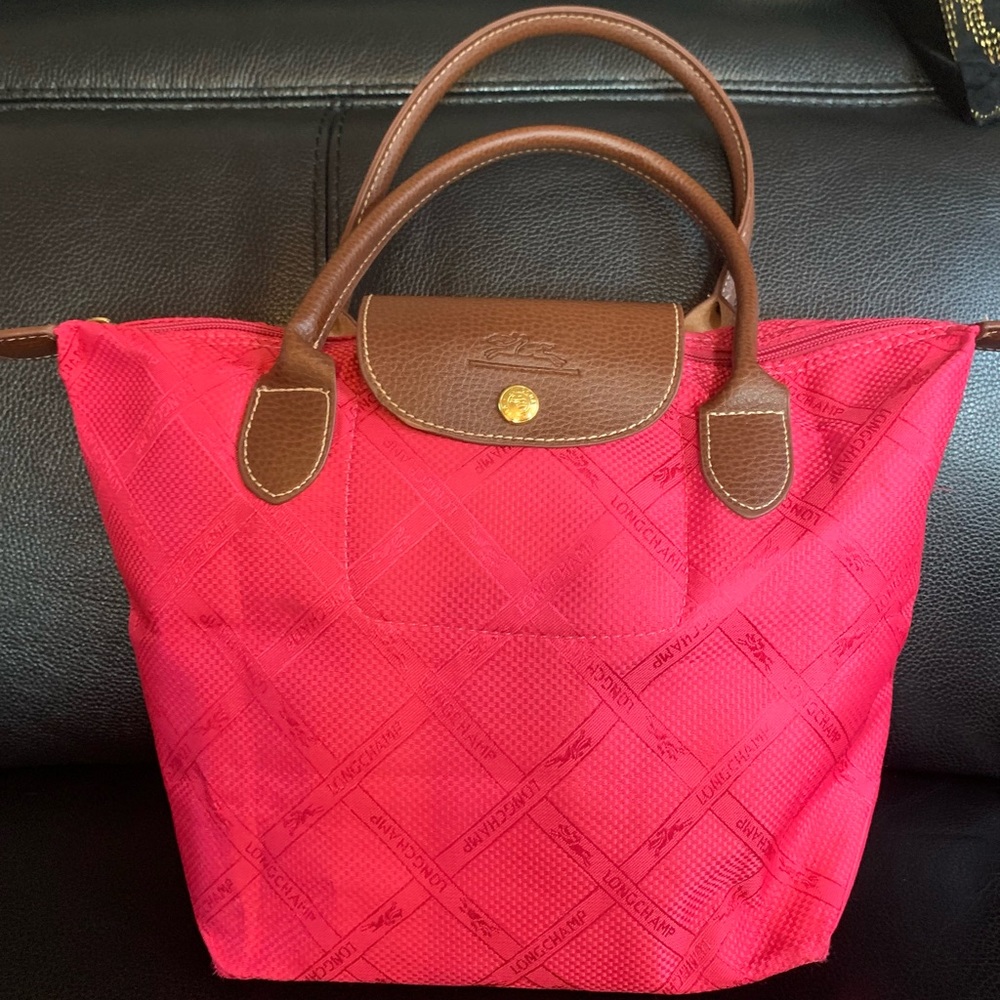 Small pink Longchamp purse.